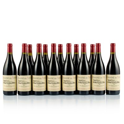 six bottles of wine lined up in a row on a white surface