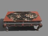 a black and red table with a painting on it