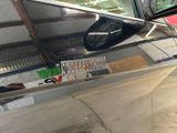 a car that is parked in a garage with its door open