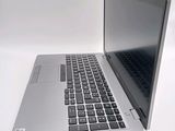 a silver laptop with a black keyboard on a white surface
