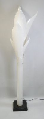 a white lamp that is on top of a table
