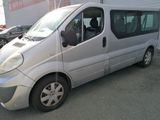 a silver van that is parked in a parking lot