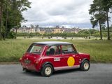 a small red car that is parked on the side of the road