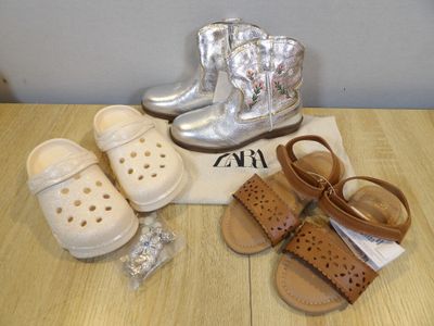two pairs of shoes and a pair of sandals on a table