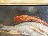 une photo d'un tableau représentant un poisson posé sur une table