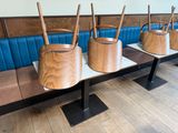 four wooden buckets sitting on a bench in a restaurant