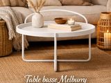 a white coffee table sitting on top of a rug in a living room