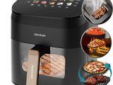 a close up of a black air fryer with a bunch of food in it