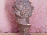 a statue of a woman ' s head sitting on a table
