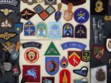 a lot of military patches on the wall