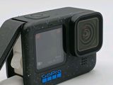 a small black camera with a small screen on top of it