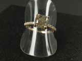 a close up of a ring with a yellow diamond in it