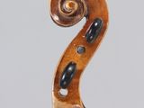 a close up of a violin with a wooden bow on a white background