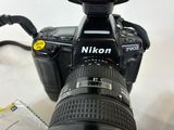 a camera that is sitting on a table with a lens attached to it