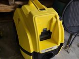 a yellow and black blow dryer sitting on the floor
