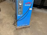 a blue machine that is sitting in a garage