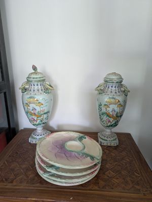 two vases and a plate on a wooden table