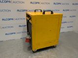 an image of a yellow machine sitting on top of a cement floor