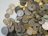 a pile of old coins on a white surface