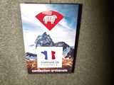 a badge on the back of a jacket with a picture of a mountain in the background