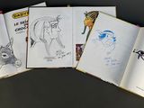several pages of comics are spread out on a table