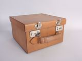 a small brown suitcase with two handles on a white surface