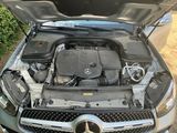 a mercedes car with the hood open and the engine in the trunk