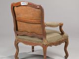 an old chair with a label on the back of it ' s arm