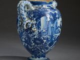 a blue and white vase with a dragon on it