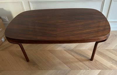 a small table with a wooden top on a hard wood floor