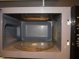 a microwave that has a tray inside of it