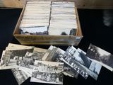 a lot of old black and white photos in a box