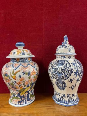 two blue and white vases sitting on a wooden table
