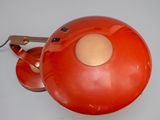 a red lamp that is sitting on a table