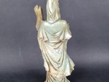 an image of a statue of a woman holding a staff