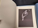 a book open on a table with a picture of a bird on it