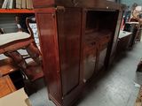 an image of a wooden entertainment center in a warehouse