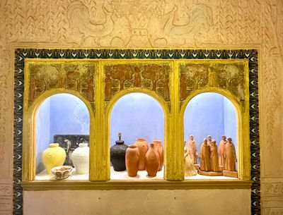 many vases on display in the window of this building