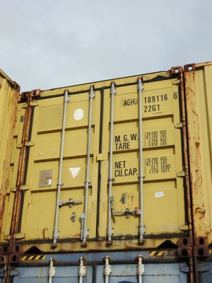 a large yellow container sitting on top of a truck