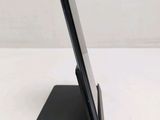 a close up of a cell phone on a stand on a table