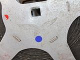 a close up of a metal object with a blue dot on it