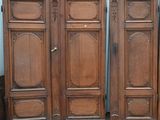 three antique wooden doors with ornate carvings on the top and bottom