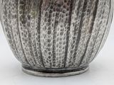 a close up of a vase on a white surface