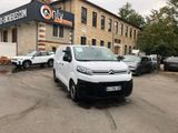 citroen van parked in front of a building with cars parked in front of it
