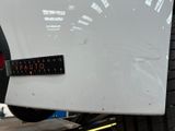 a sticker on the back of a white car