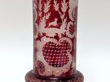 a red vase with a pattern on it on a stand