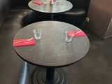 two tables with place settings on them in the corner of a restaurant