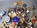 many different types of badges and badges on a table