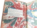 an open book with a page in it on a table