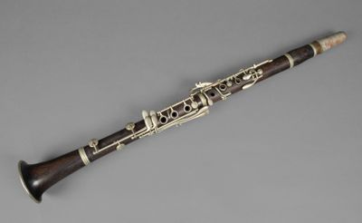 a close up of a clarinet on a gray surface